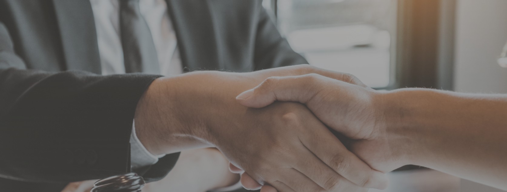 Mobile notary and client shaking hands after a signing